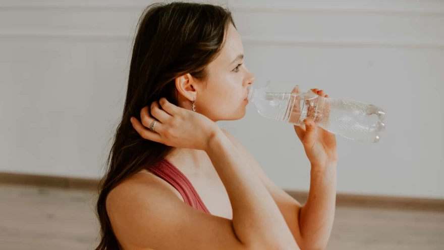 γυναίκα πίνει ένα μπουκάλι νερό