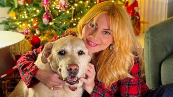 Η Σμαράγδα Καρύδη μπροστά από το χριστουγεννιάτικο δέντρο με τον σκύλο της