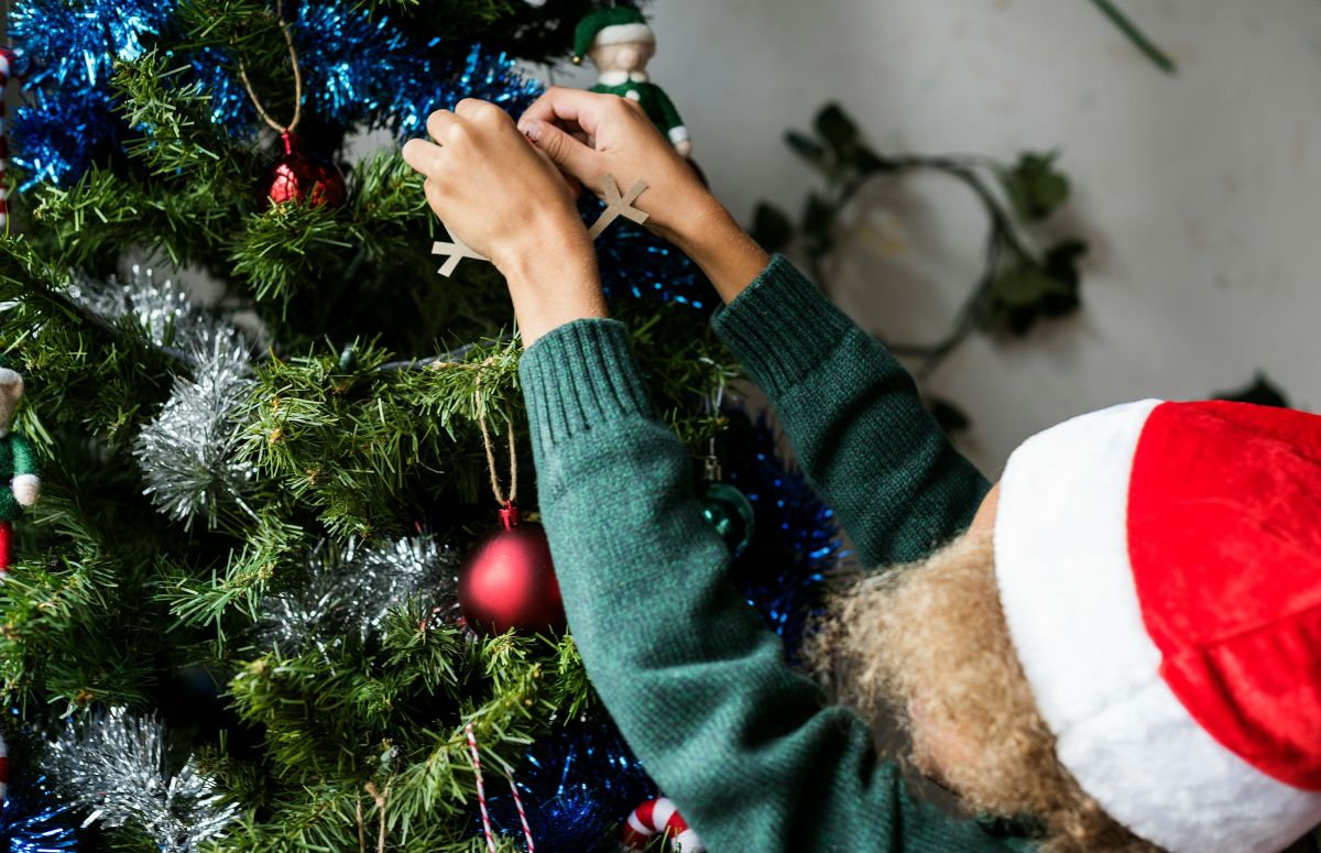 Ένα παιδάκι στολίζει το χριστουγεννιάτικο δέντρο