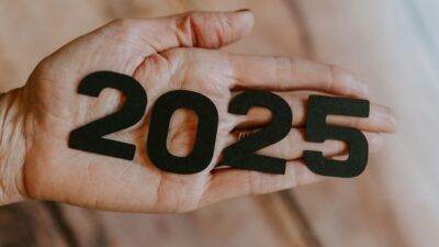 ένα χέρι κρατά αριθμούς που σχηματίζουν το 2025